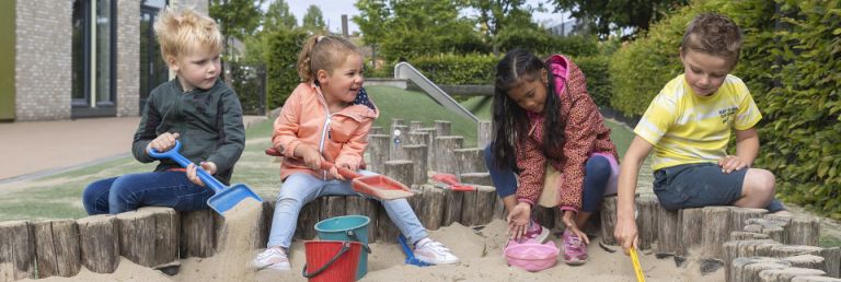 Kinderen spelen in de zandbak.