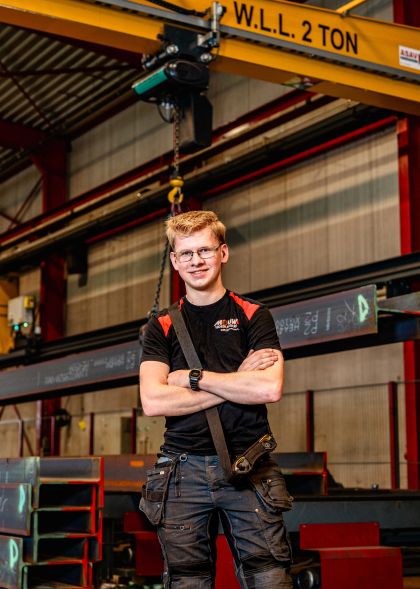 Meewerkend Operator staat met armen over elkaar en kijkt richting camera