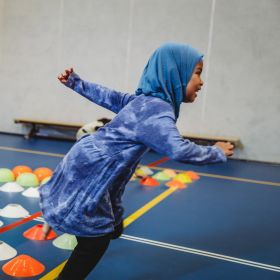 A girl sprints happily during gym class A girl sprints happily during gym class