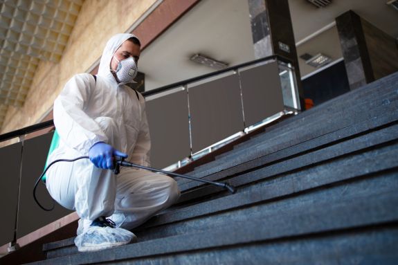 person-white-chemical-protection-suit-disinfecting-public-corridors-steps-stop-spreading-highly-contagious-corona-virus