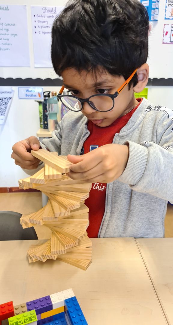 kg child playing with wooden blocks copy