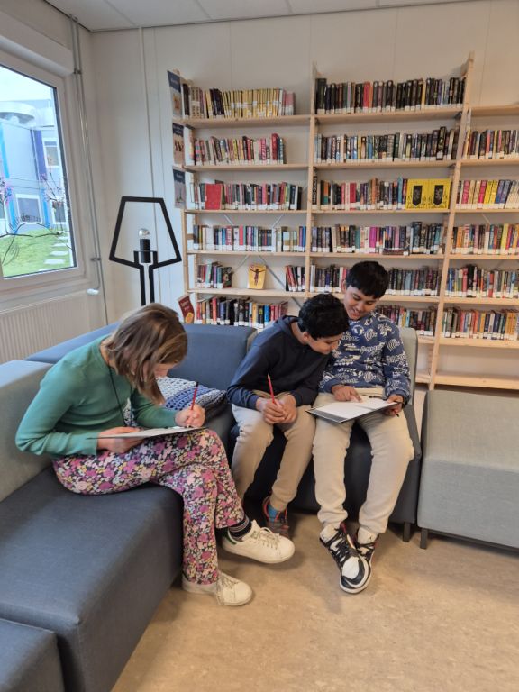 Secondary students in the library engrossed in their books