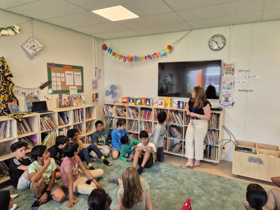 Picture of a primary class during a library lesson in the primary library