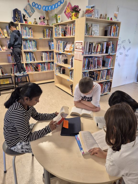 Lower secondary students reading in the school library