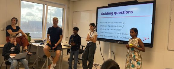 Middle school students in class with their mentor