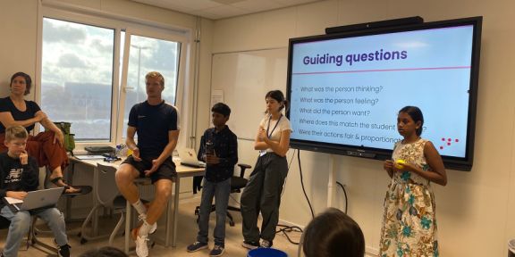 Middle school students in class with their mentor